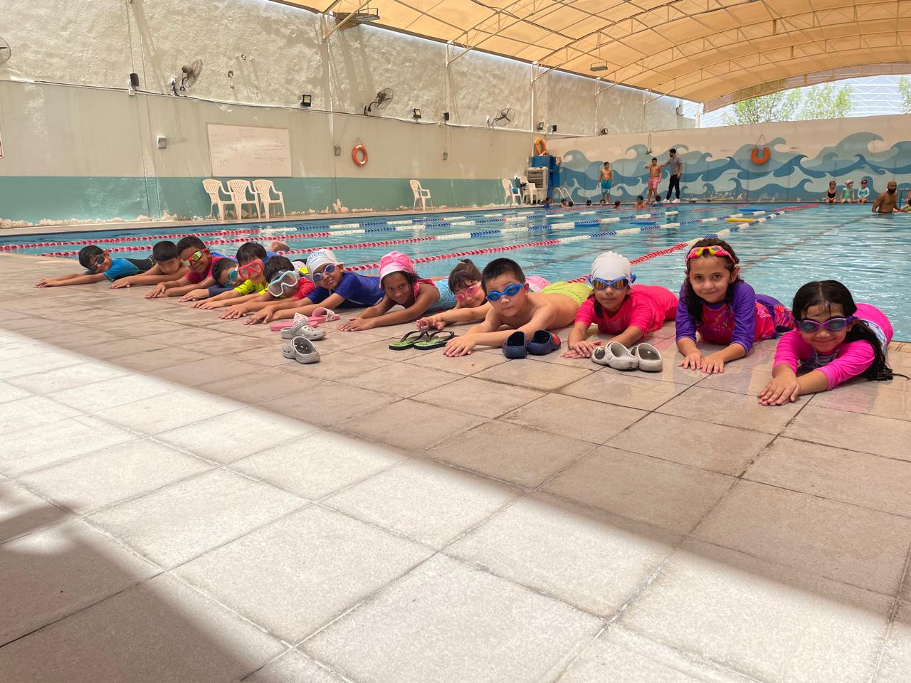 Children practicing swimming strokes